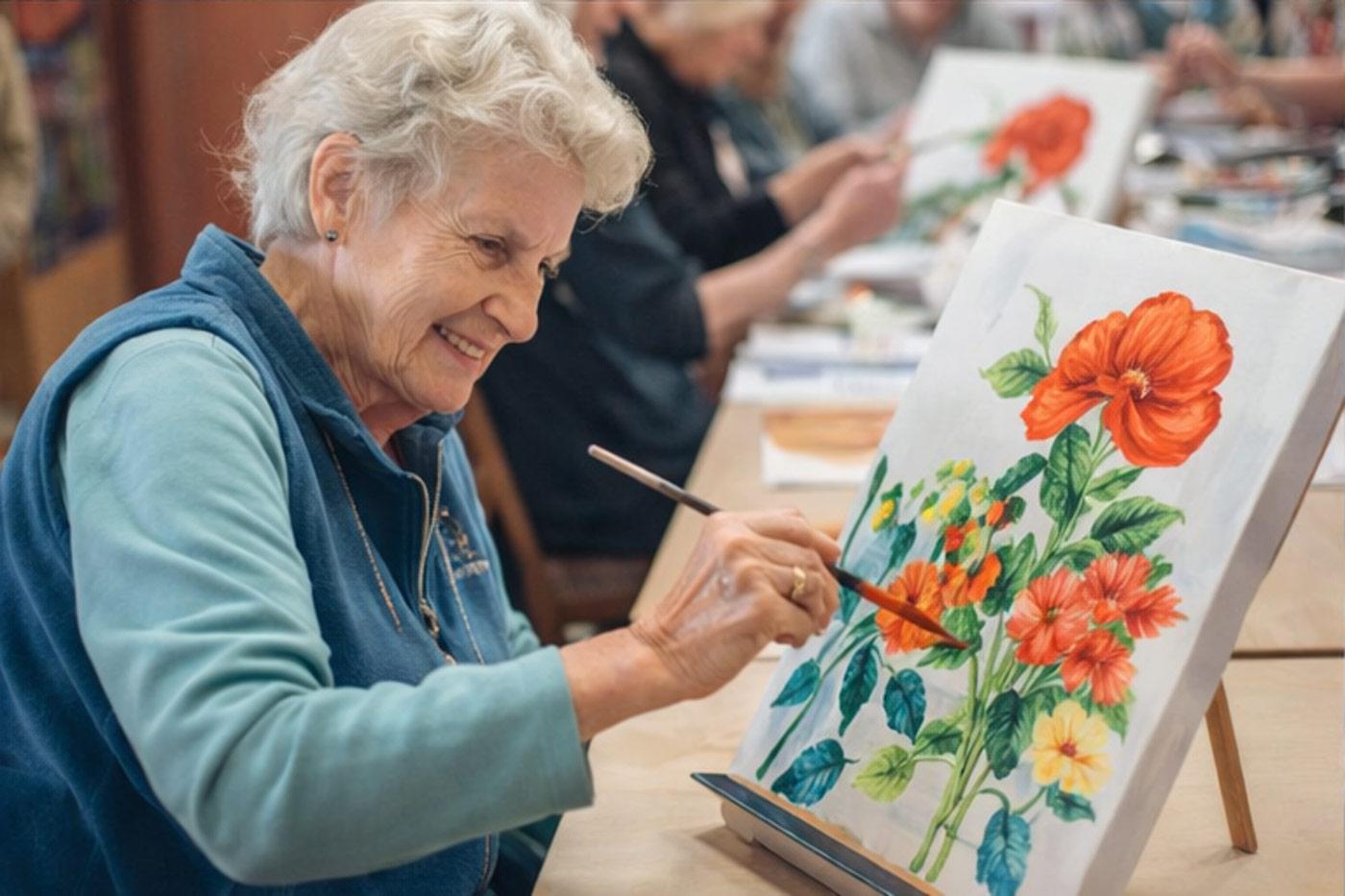 Resident participating in art class at The Commons senior living community in Grand Junction
