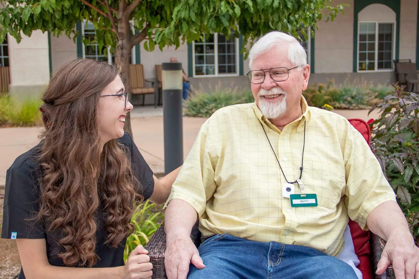 Caregiver providing personalized assisted living support to resident at The Commons of Hilltop in Grand Junction